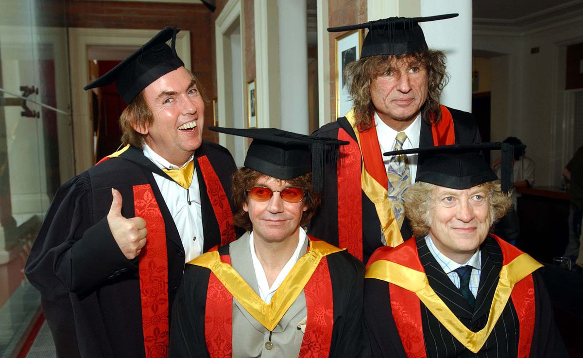 Noddy Holder, Dave Hill, Jim Lea and Don Powell, collect their honorary followships from their home town University of Wolverhampton