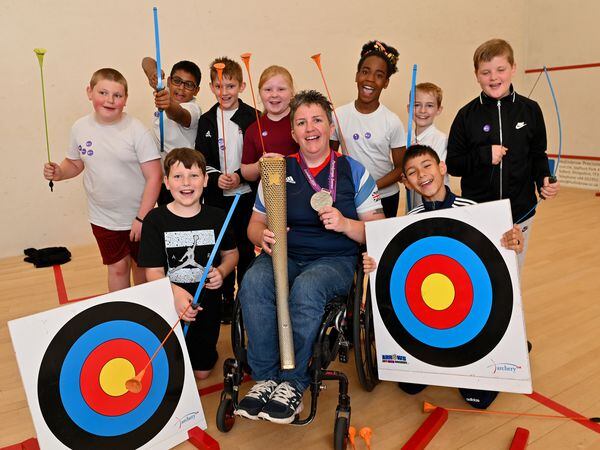 Archery medallist Mel Clarke with kids.