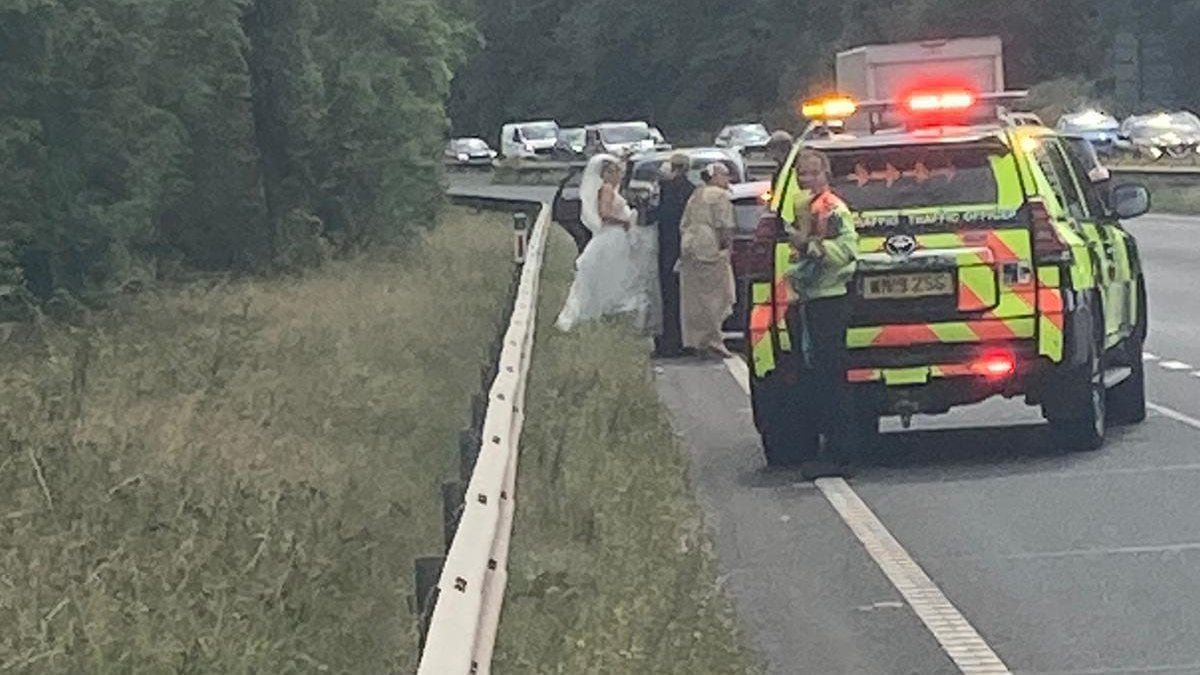 Police arrive to help the stranded bridal party. Photo: @TrafficWalesN