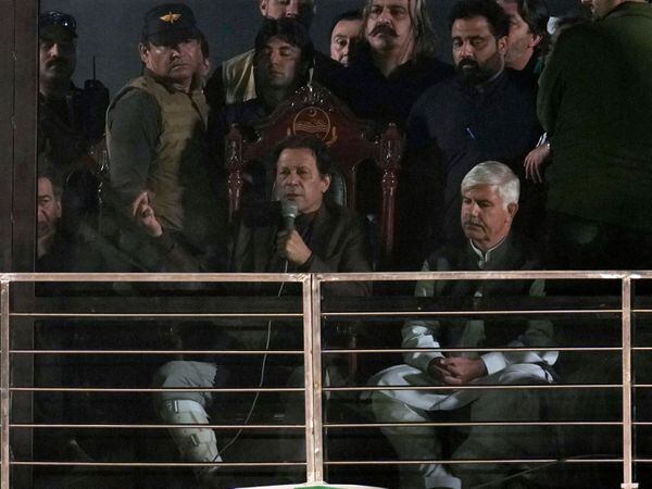 Pakistan’s former Prime Minister and opposition leader Imran Khan, center in seated, addresses to his supporters during a rally, in Rawalpindi, Pakistan