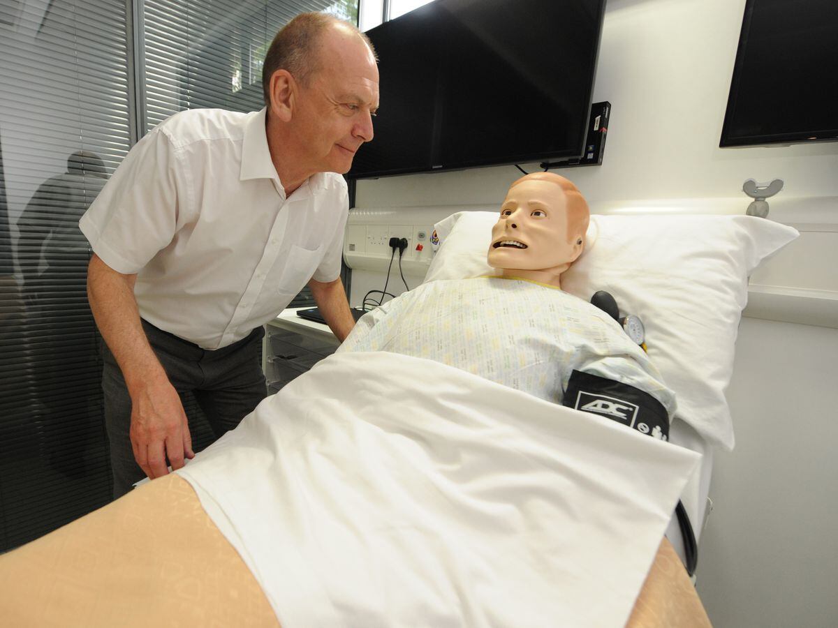 Vice-chancellor Prof Geoff Layer checks on the welfare of a robotic patient