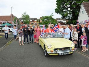 'The Queen' arrives at a Jubilee party at Holly Close Kinver in a 1971 MGB.