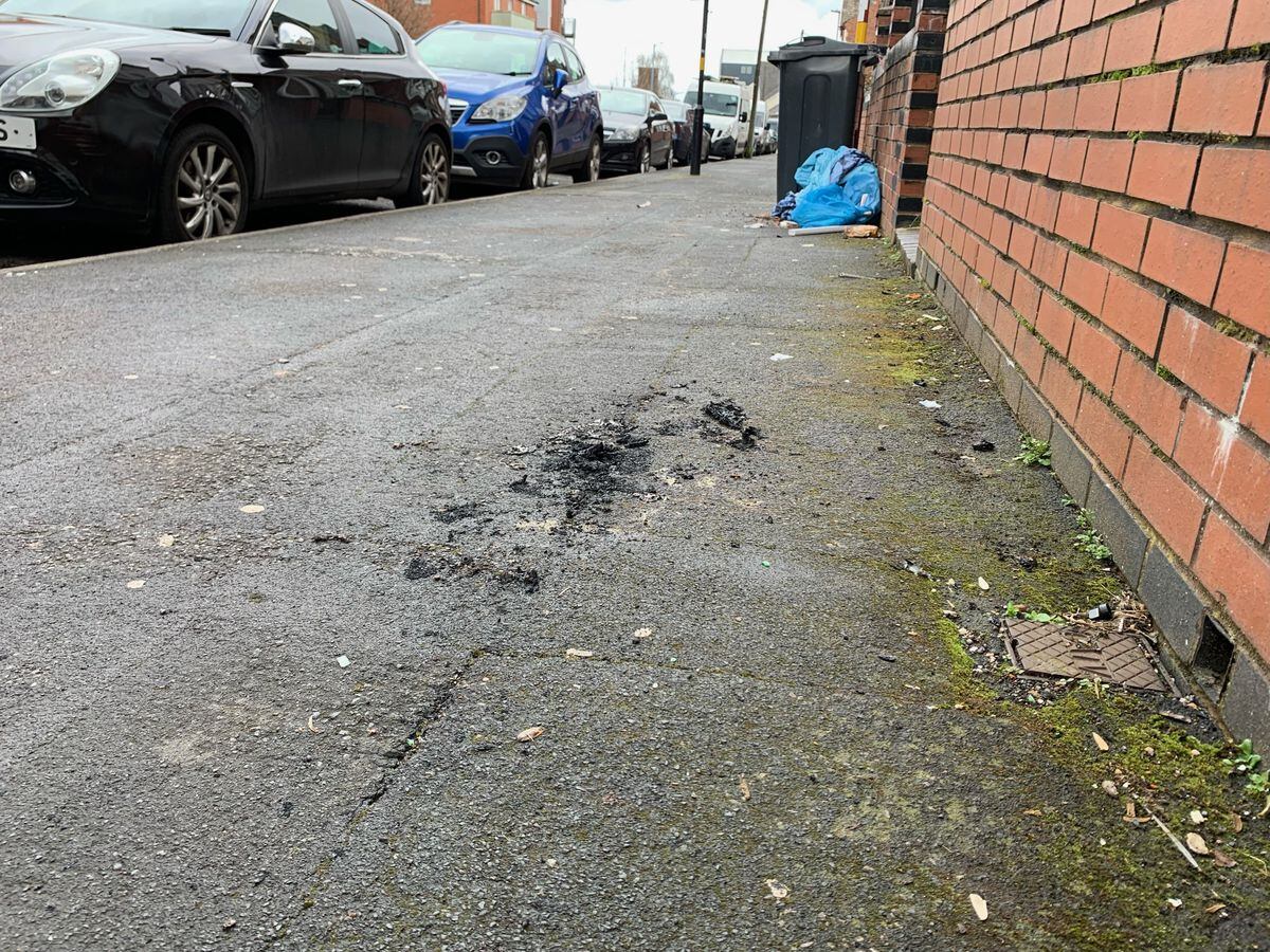 Charred remnants of materials on the pavement of Shenstone Road, Birmingham, where the suspected arson attack happened