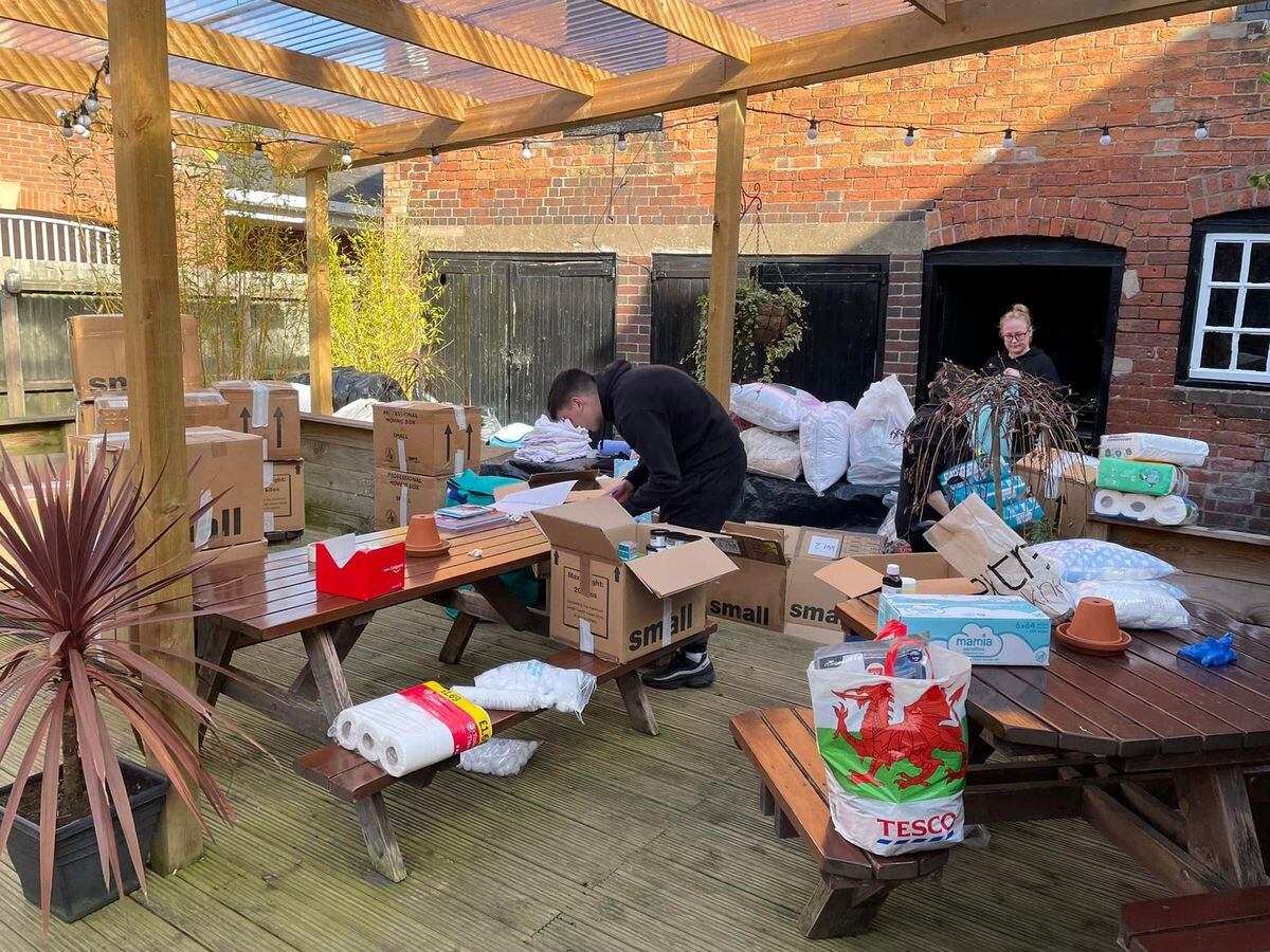 Staff members at The Kings Arms sort the donated items