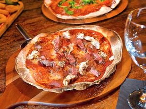 ‘All the meats’ pizza with  medium-rare steak, prosciutto, ham, salami, pepperoni and chicken					