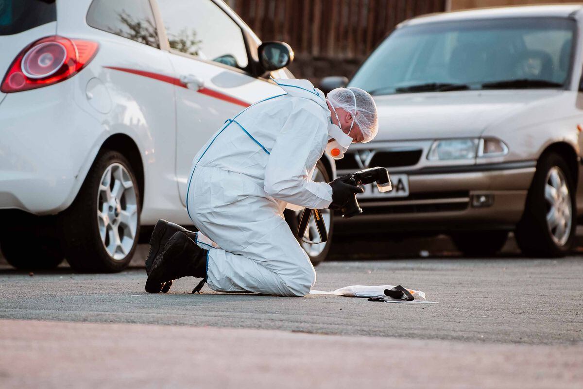 A forensic officer photographs potential evidence