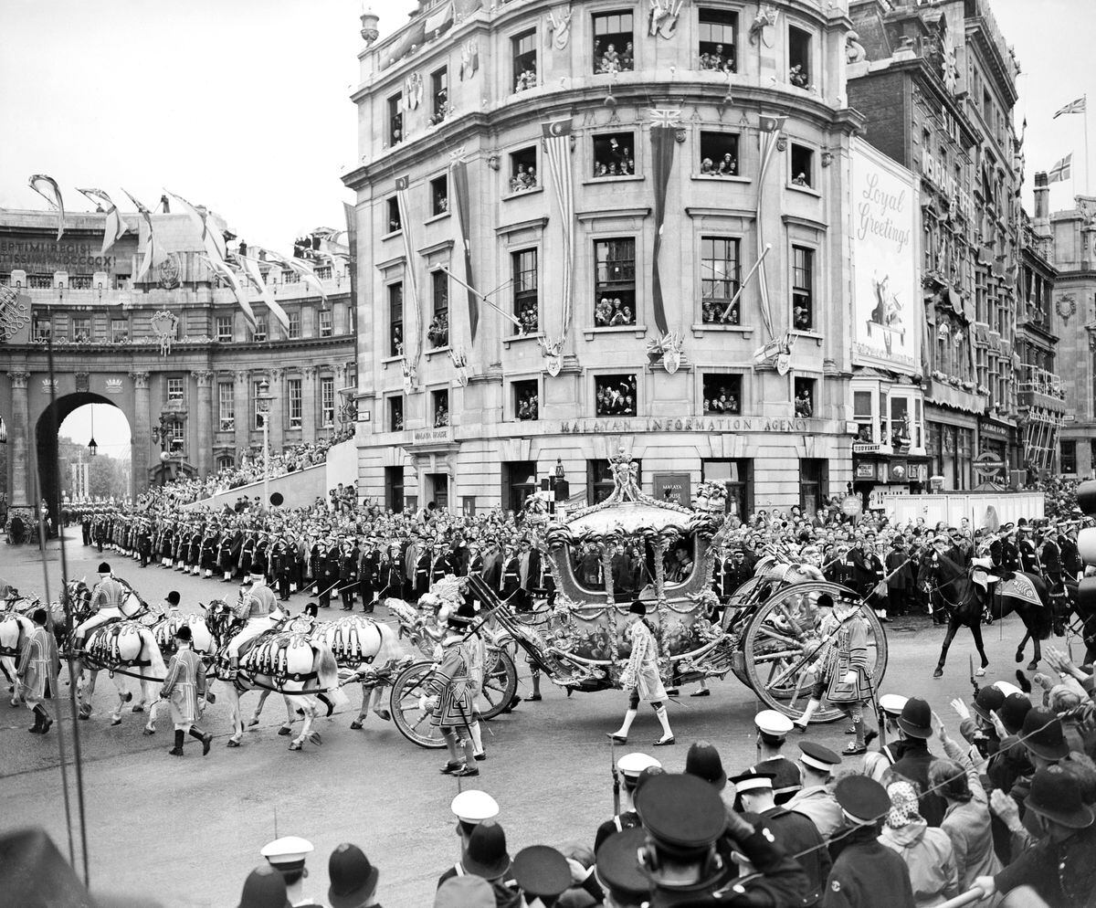 File photo dated 2/6/1953 of Queen Elizabeth II in the Gold State Coach returning to Buckingham Palace, London, after the Coronation. The King and Queen Consort will travel to the coronation in the modern Diamond Jubilee State Coach and return in the historic Gold State Coach. Issue date: Friday April 28, 2023. PA Photo. See PA story ROYAL Coronation Carriages. Photo credit should read: PA Wire.