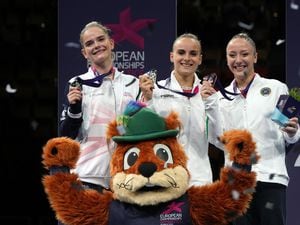 Asia D'Amato (gold, Italy), Alice Kinsella (left, silver, Great Britain) and Martina Maggio (right, bronze, Italy) with their medals and mascot Gfreidi during the award ceremony for the all-around women Gymnastics on day one of the European Championships 2022 holder..