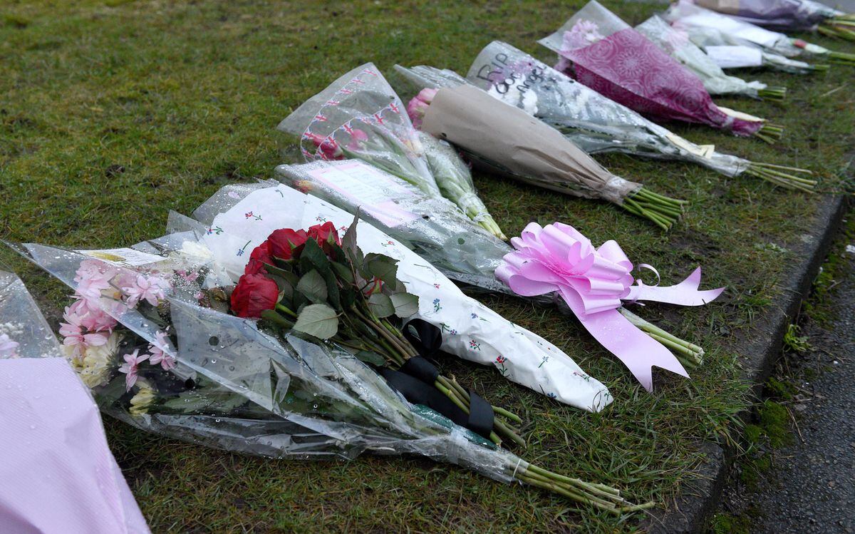 Scores of flowers have been placed by the cordon