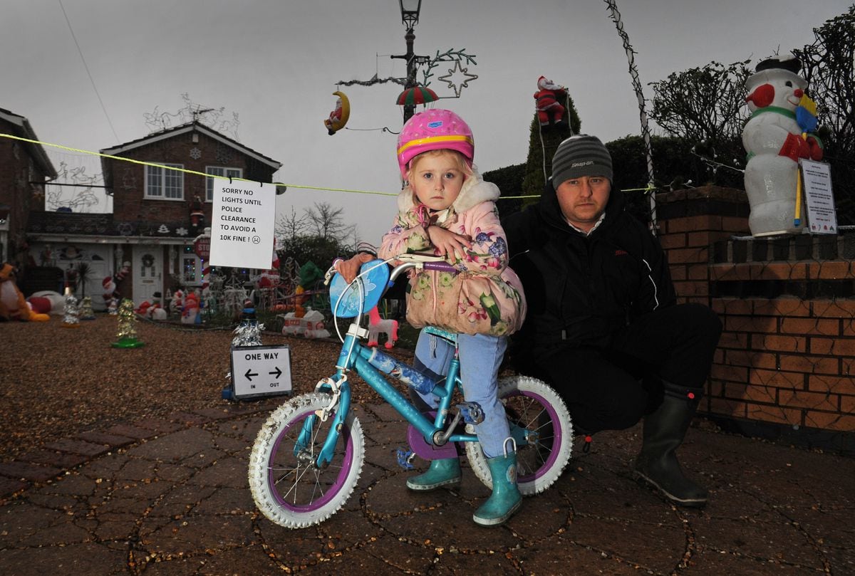 Tilly Tomlinson, aged five, with her father Mark Tomlinson near the Christmas lights.