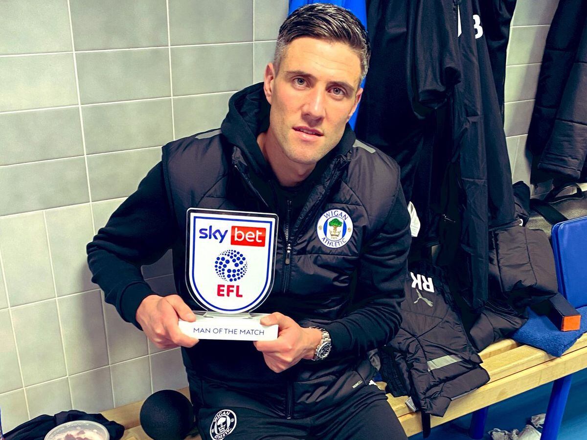 Martin Kelly tweeted a picture of him holding his man of the match award with his knee in a brace following his Wigan debut at Blackburn. Pic: Twitter