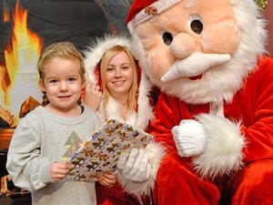 Children visiting the Landywood school Santa's grotto outside. Pictured left with Santa are Amelia Belsy age three and Charlie Titley