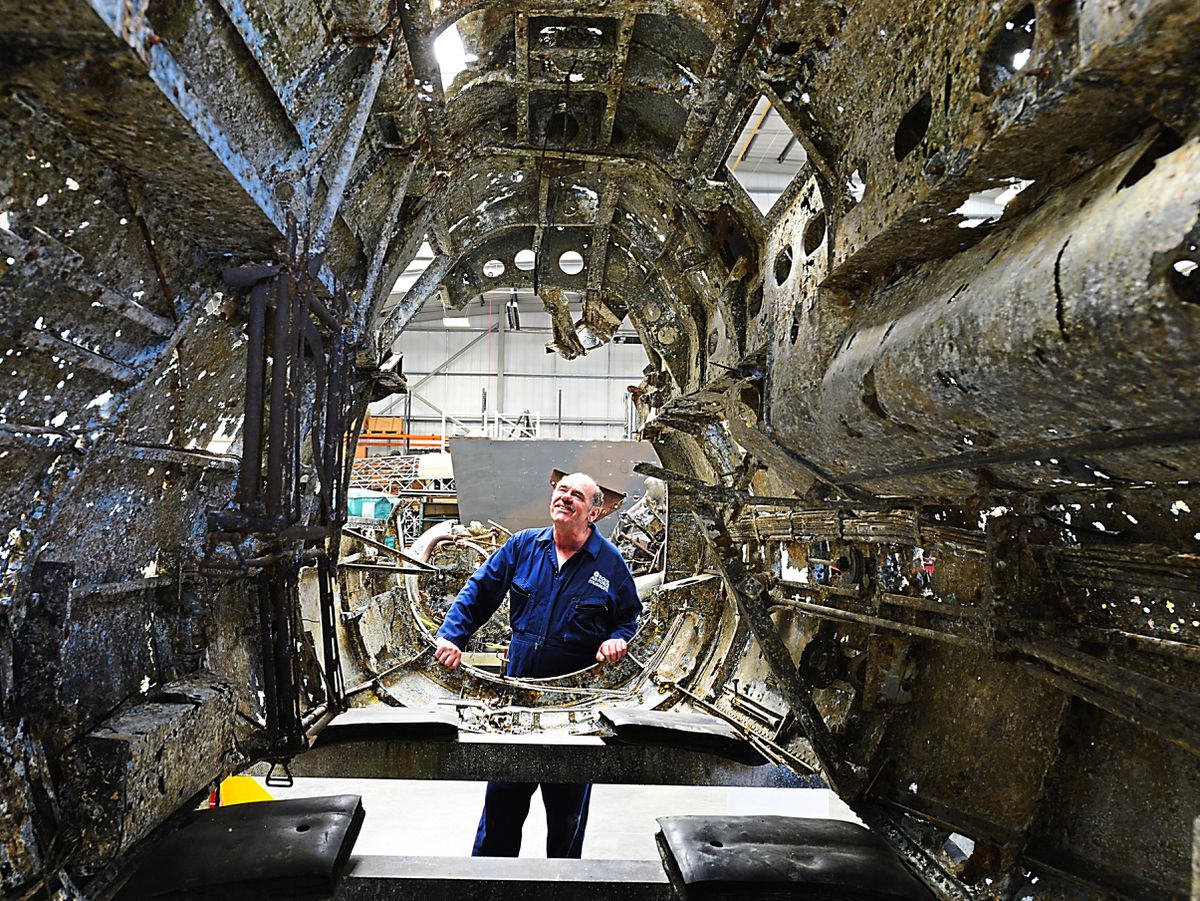 Aircraft technician John Warburton, from Telford, looks at the fuselage of the historic Dornier, which is now set to remain at RAF Cosford Museum