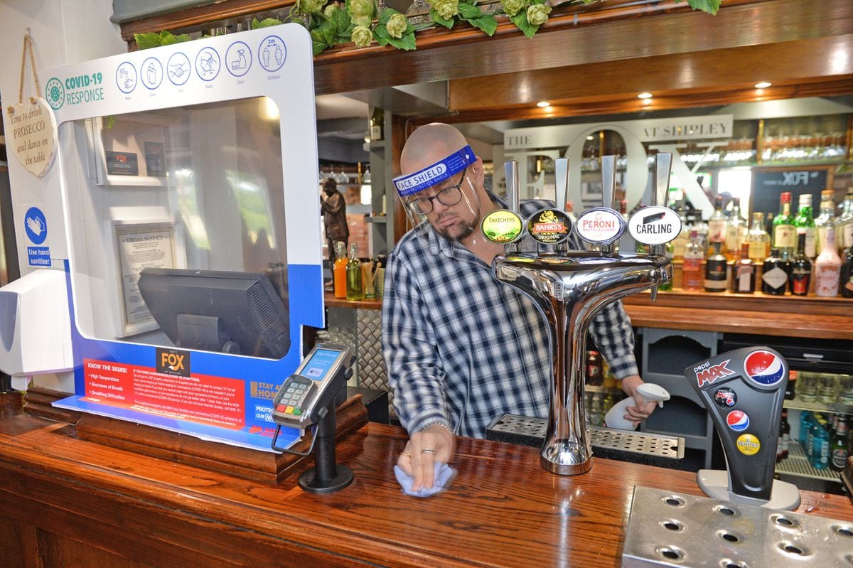 Ross Tapsell cleans down the counter at The Fox at Shipley.