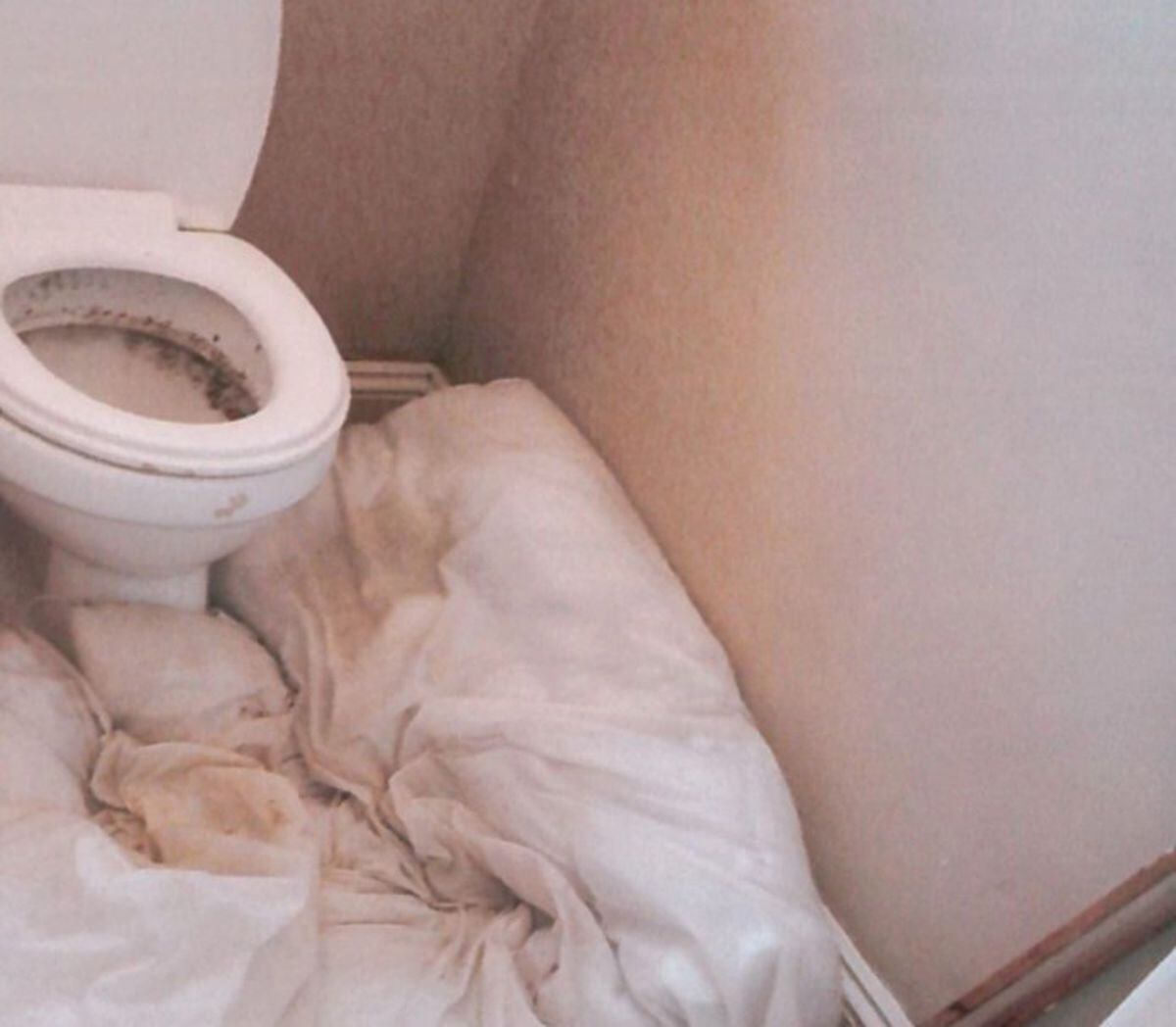 A leaky toilet which had to be plugged with an old duvet by the trafficking victims