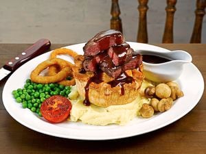 Eyes on the pies – the steak on top of a steak pie steak chips, peas and onion rings
