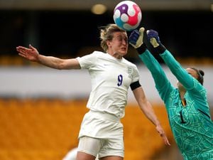 England's Ellen White (left) attempts to head the ball under pressure from Belgium goalkeeper Nicky Evrard during the women's international friendly match at Molineux, Wolverhampton. Picture date: Thursday June 16, 2022. PA Photo. See PA story SOCCER England Women. Photo credit should read: Nick Potts/PA Wire...RESTRICTIONS: Use subject to FA restrictions. Editorial use only. Commercial use only with prior written consent of the FA. No editing except cropping.