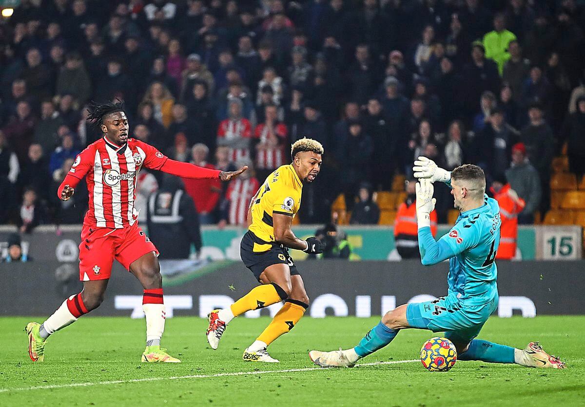 WOLVERHAMPTON, ENGLAND - JANUARY 15: Adama Traore of Wolverhampton Wanderers scores their team's third goal past Fraser Forster of Southampton during the Premier League match between Wolverhampton Wanderers and Southampton at Molineux on January 15, 2022 in Wolverhampton, England. (Photo by Jack Thomas - WWFC/Wolves via Getty Images).