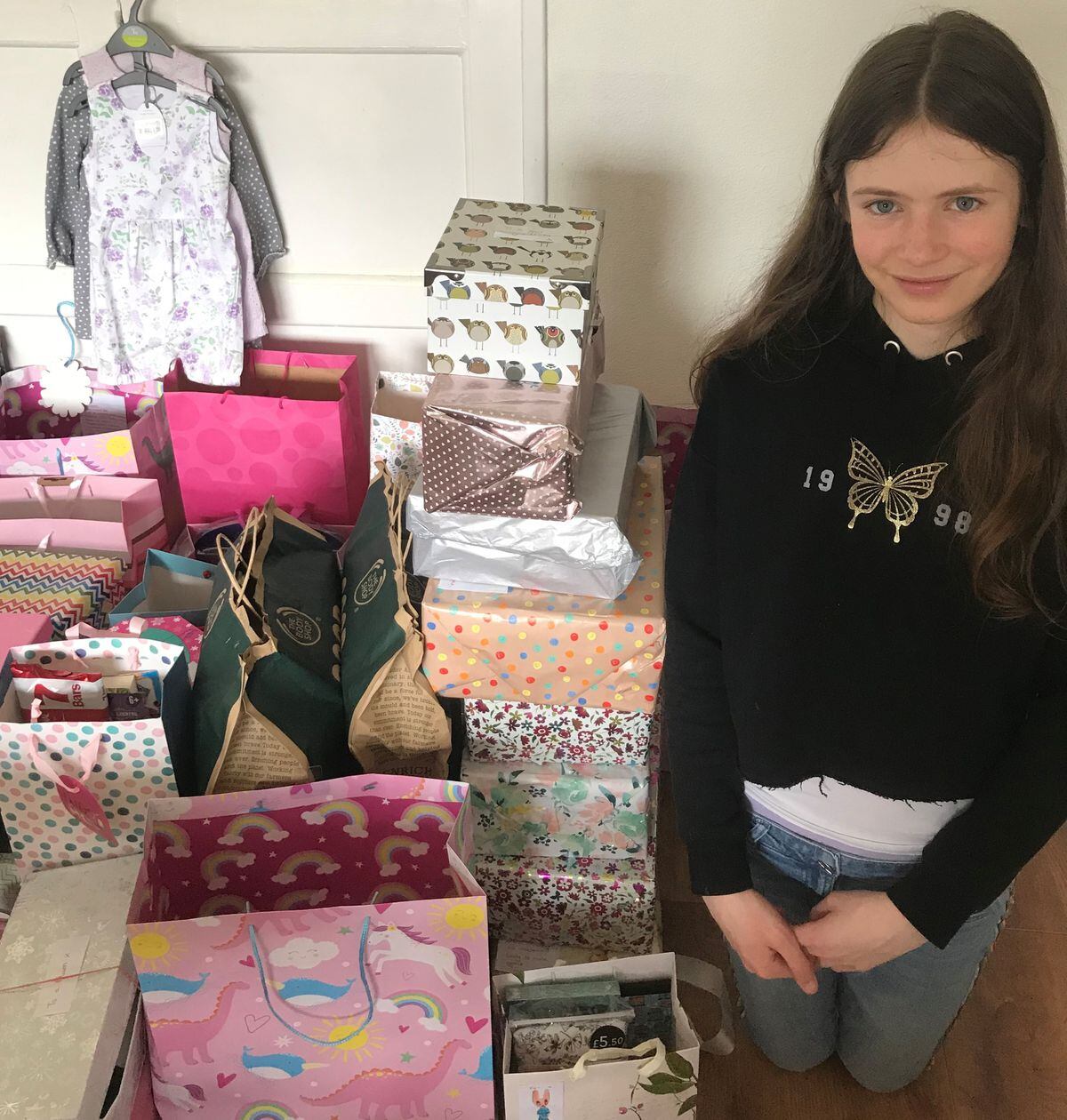 Honor Sutton, with some of the 67 gift-filled boxes and bags she created