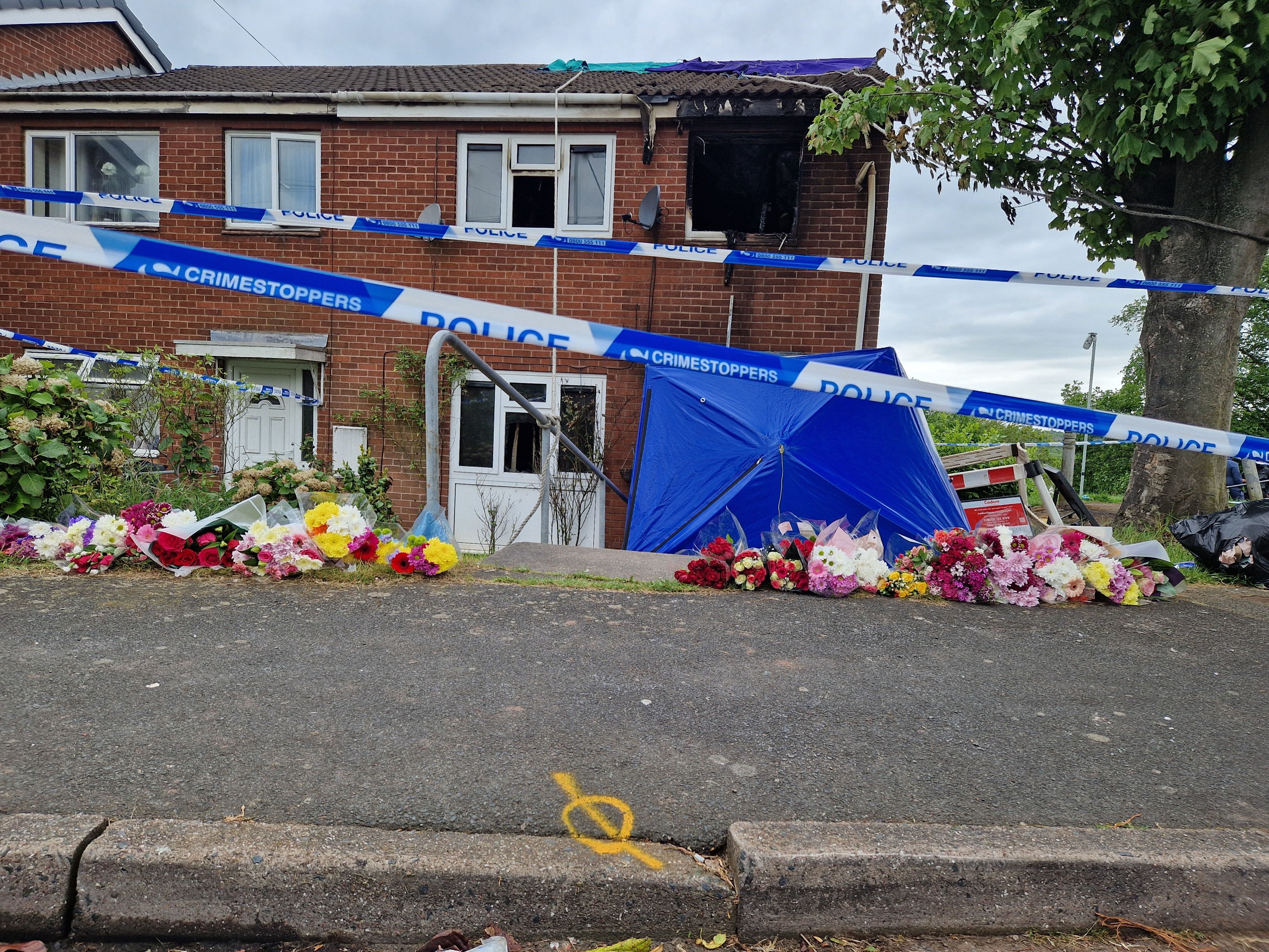 Sea of tributes left at Wolverhampton house after deadly fire prompts murder probe