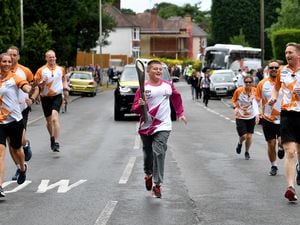 Marcus Galli jogs along the course with members of West Midlands Police