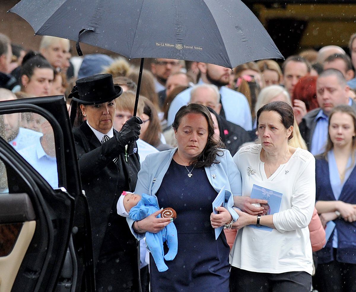 Mylee's mother Tracey Taundry carrying a doll and a piece of Mylee's favourite cake at her funeral in April