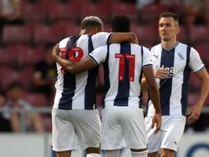 Karlan Grant of West Bromwich Albion celebrates after scoring a goal to make it 0-2 with Grady Diangana of West Bromwich Albion and Jed Wallace of West Bromwich Albion at Sixfields on July 13, 2022 in Northampton, England. (Photo by Adam Fradgley/West Bromwich Albion FC via Getty Images).