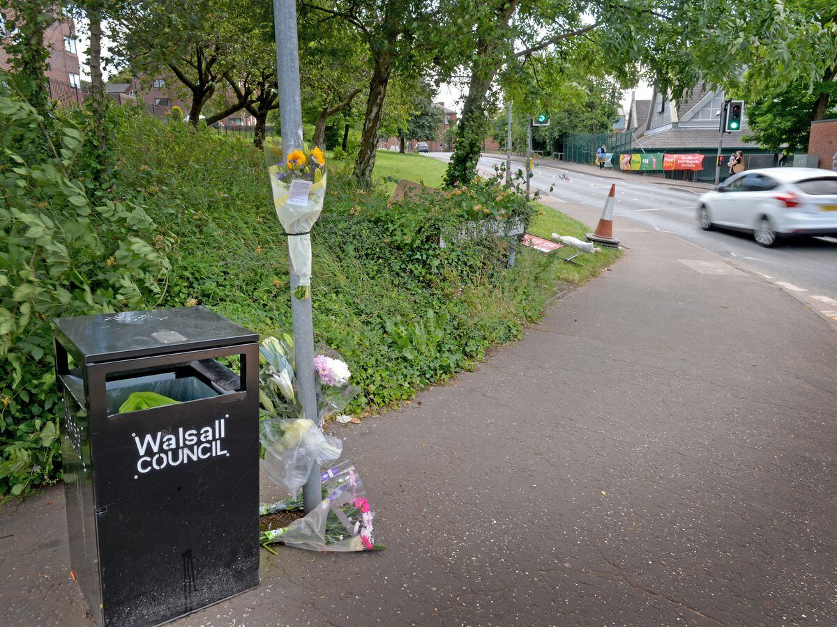 Tributes at the scene of the crash where a cyclist died after being hit on the crossing on Tuesday morning on Lower Rushall Street, Walsall