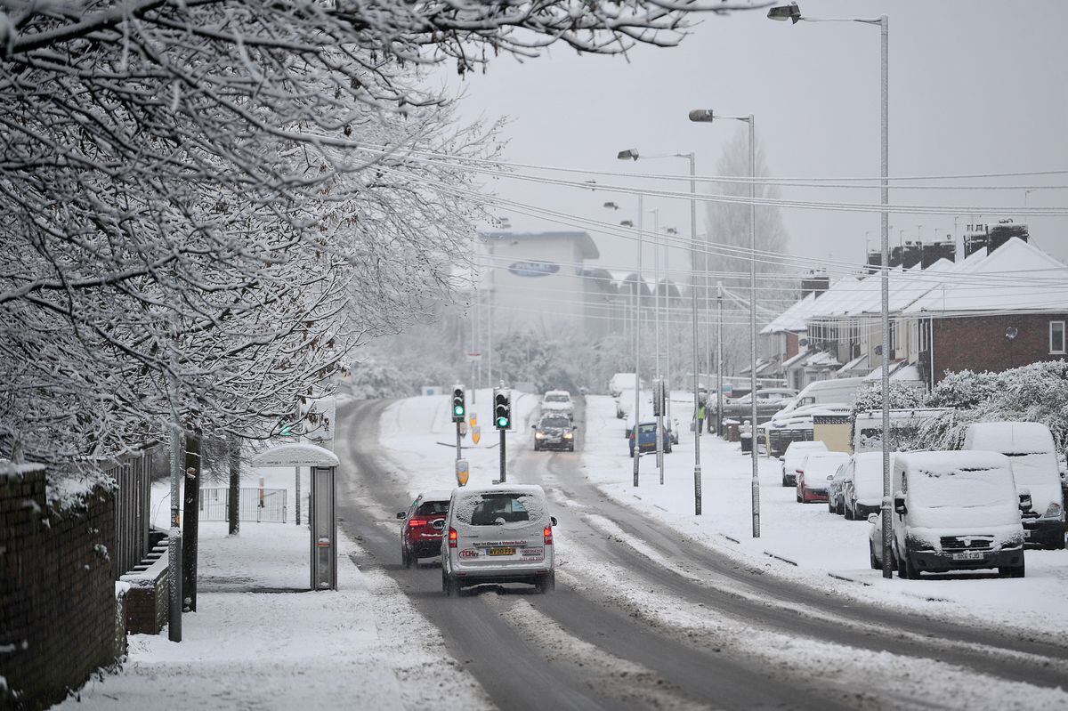 Cars navigate the snow in Bilston