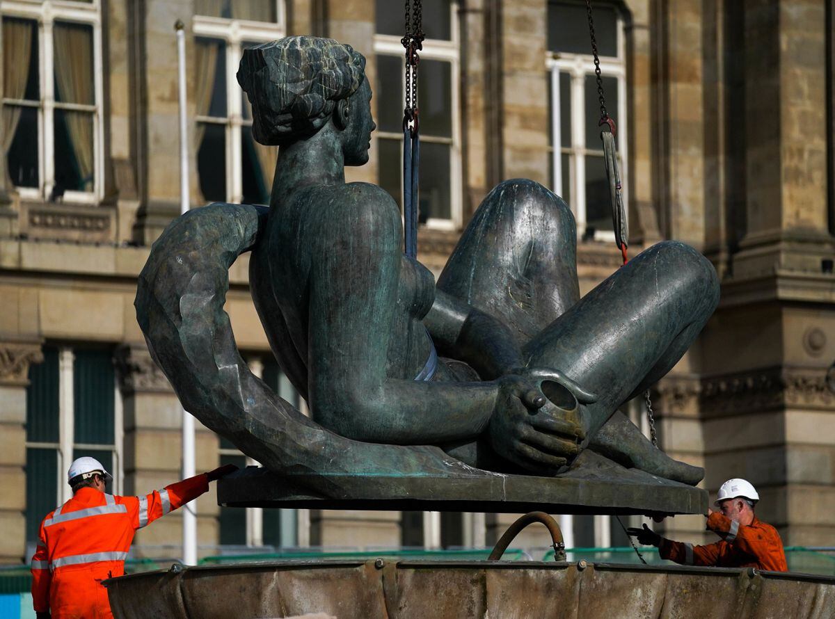The 'Floozie in the Jacuzzi' is lifted out of its fountain in Victoria Square