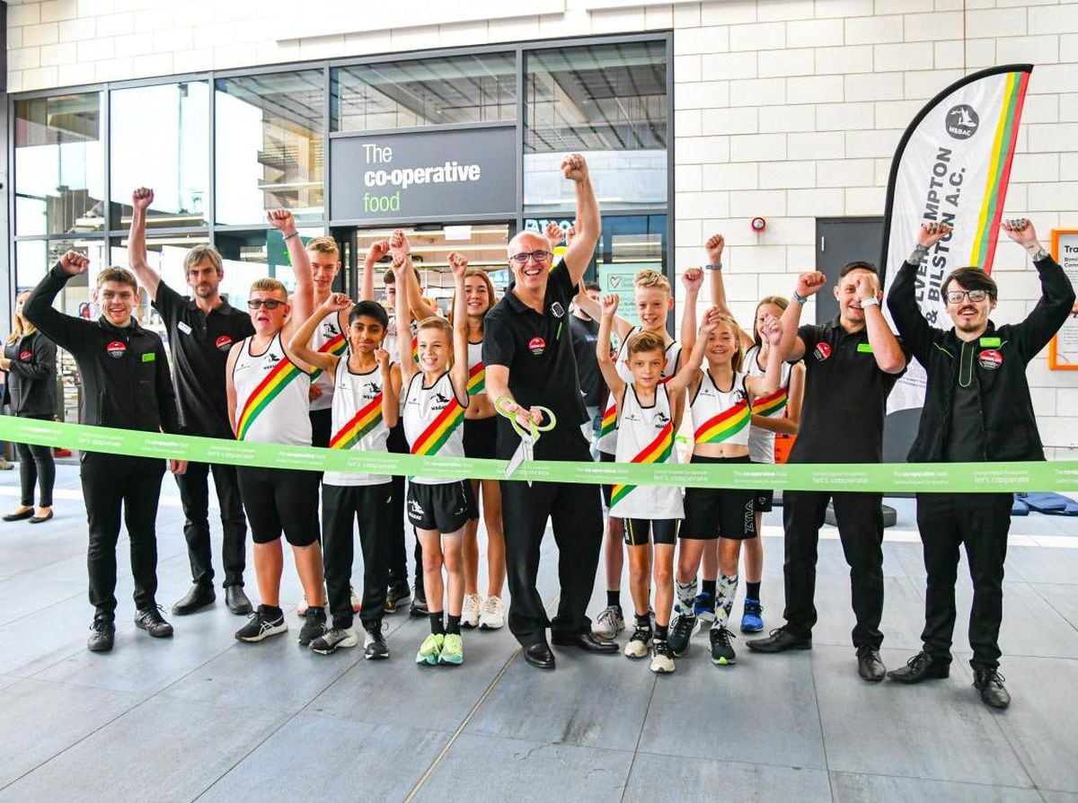  Central England Co-op store manager Carl Smitheman and his colleagues joined by young athletes from Wolverhampton and Bilston AC Club to cut the ribbon