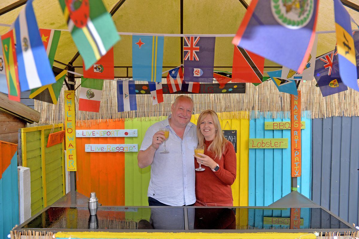 Mark and Lynn Marshall have created a Caribbean beach bar in their back garden during lockdown.