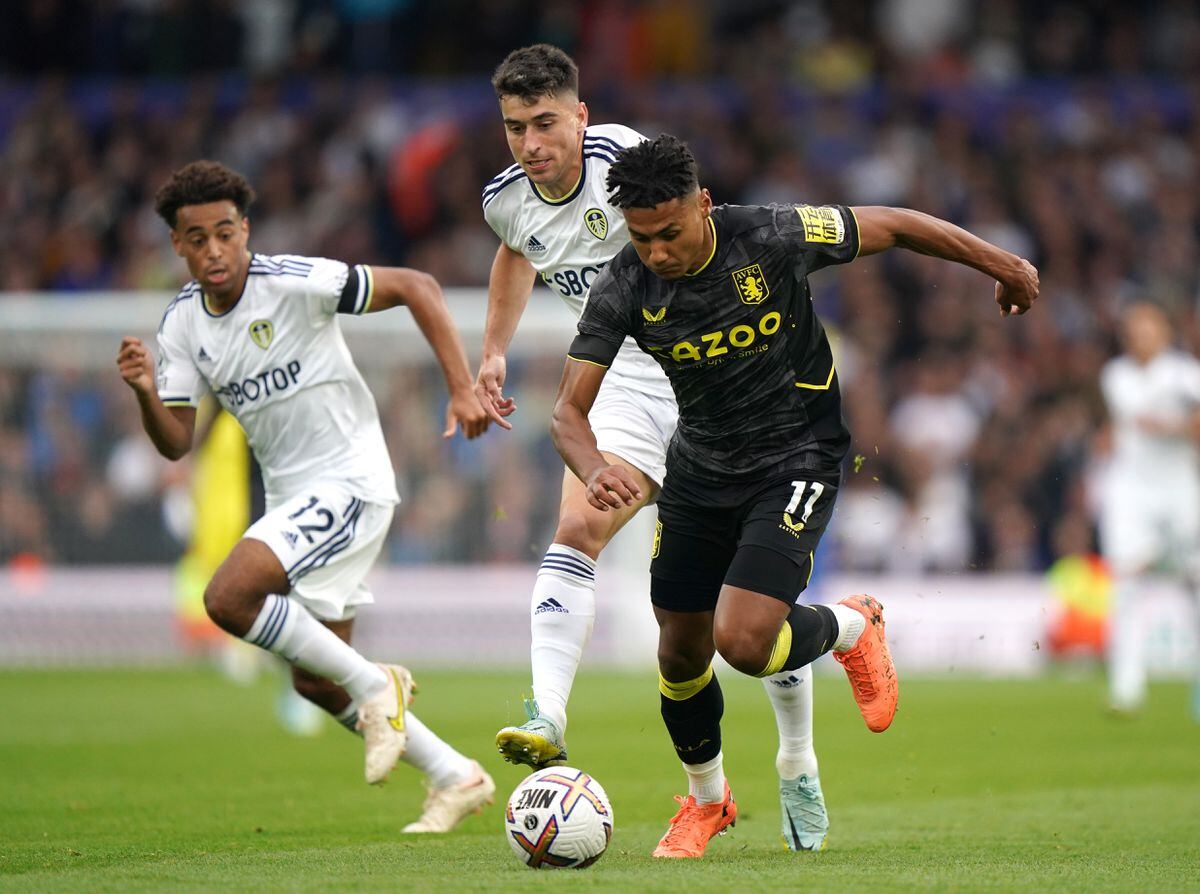 Aston Villa's Ollie Watkins (right) gets past Leeds United's Marc Roca during the Premier League match at Elland Road, Leeds. Picture date: Sunday October 2, 2022.