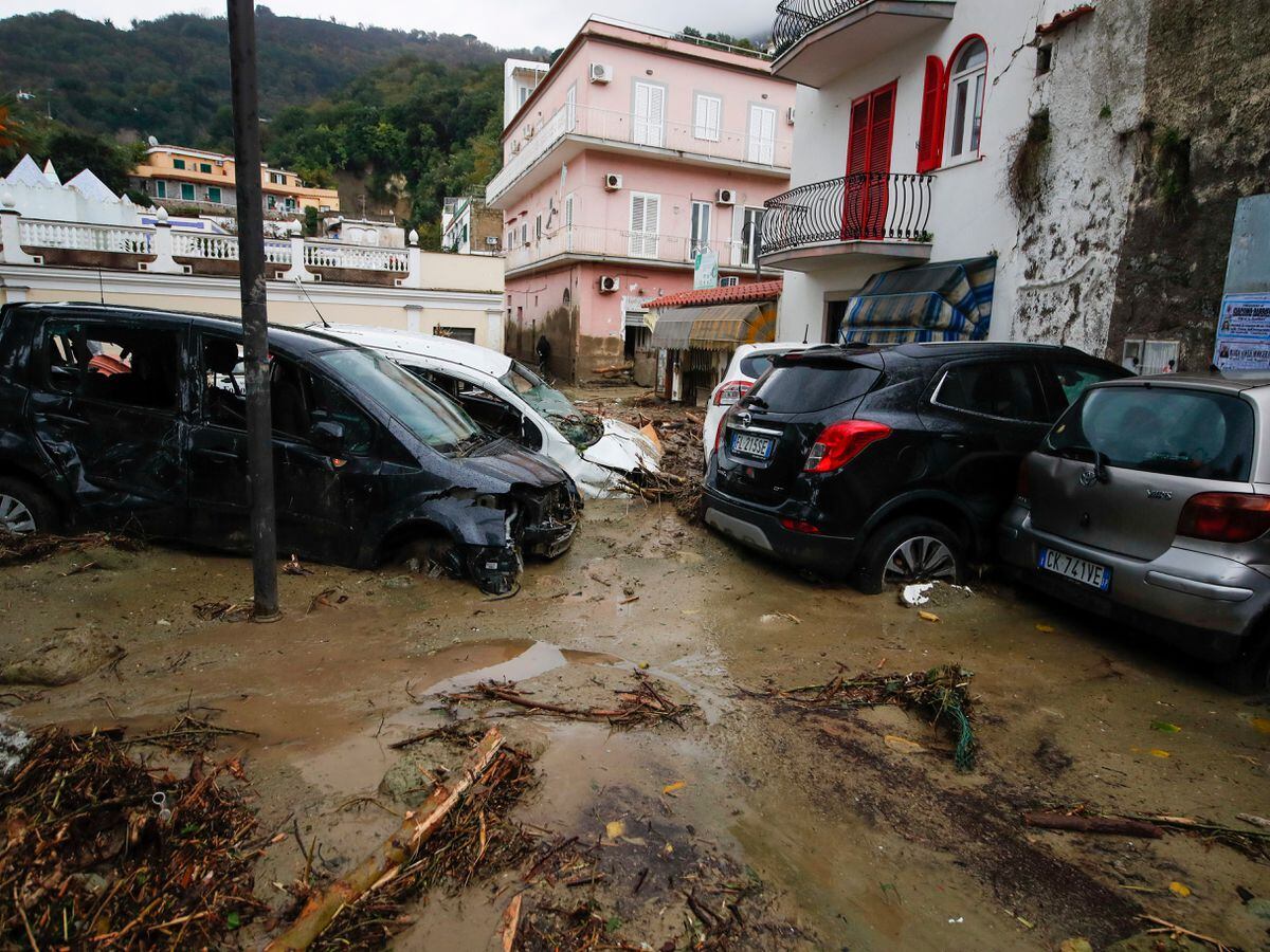Damaged cars in a flooded road