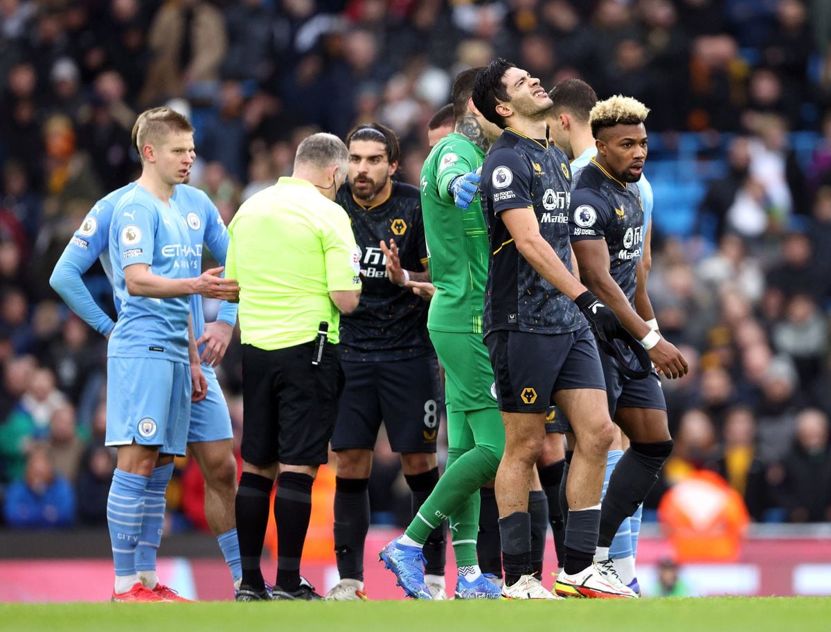 Wolverhampton Wanderers' Raul Jimenez (second right) reacts after being shown a second yellow card during the Premier League match at the Etihad Stadium.