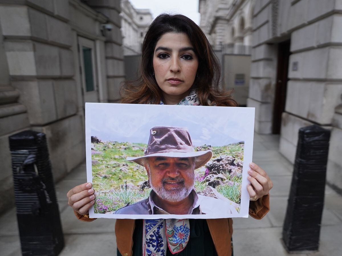 Roxanne Tahbaz holds a picture of her father, Morad Tahbaz