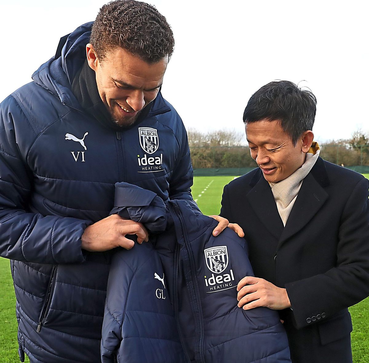 WALSALL, ENGLAND - DECEMBER 15: Valerien Ismael Head Coach / Manager of West Bromwich Albion gives a bench coat to Guochuan Lai Owner / Controlling Shareholder of West Bromwich Albion at West Bromwich Albion Training Ground on December 15, 2021 in Walsall, England. (Photo by Adam Fradgley/West Bromwich Albion FC via Getty Images).