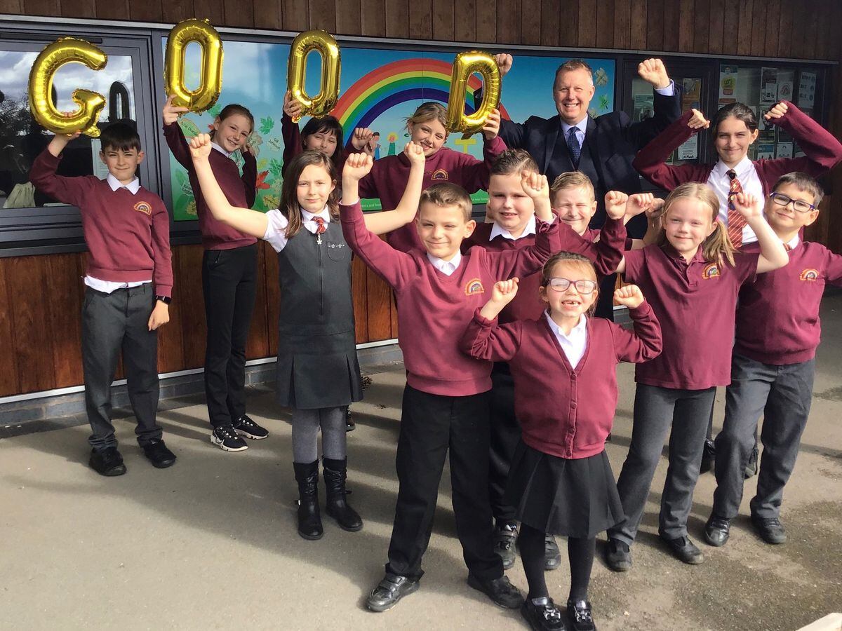 Headteacher Ian James celebrates the Ofsted rating with members of the school council