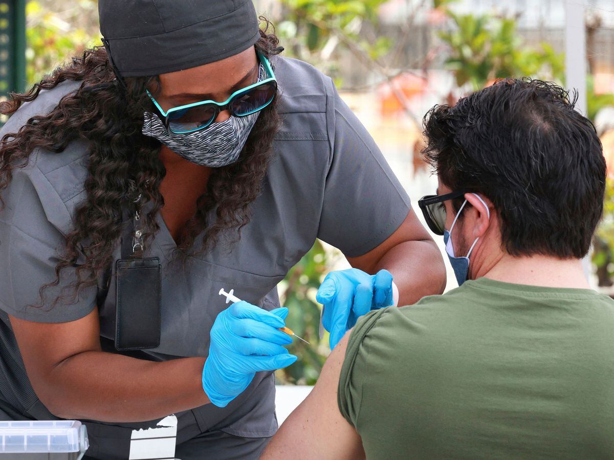 An Orange County resident receives the Covid-19 vaccine in Orlando