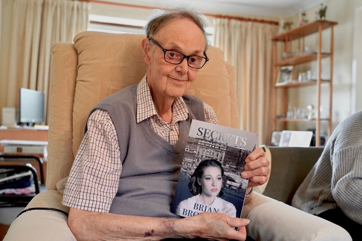 Brian pictured with his book Secrets after becoming an author for the first time at 84