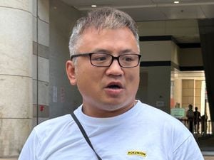 The Hong Kong Journalists Association’s chairman Ronson Chan speaks to reporters outside court in Hong Kong on Monday