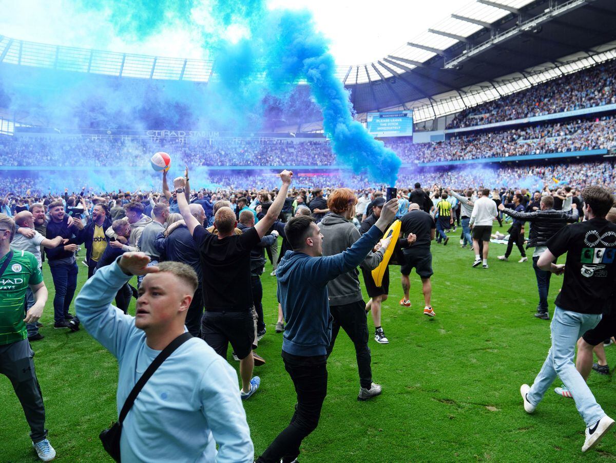 Manchester City fans invade the pitch 