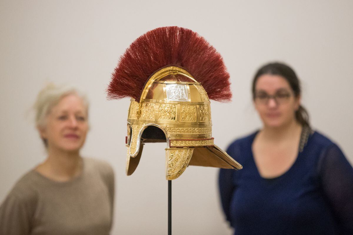 Staff admire the replica helmet that would have had a very high status owner and possibly even have been worn by a king