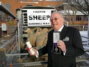 Dr Roy Richardson 'drives sheep through the town' as is the ceremonial right of the Freeman of the Borough. Photo: Sandwell Council.