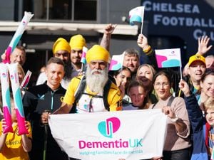 Manny Kang with supporters at Stamford Bridge on Saturday after he walked the entire way from Wolverhampton to raise tens of thousands of pounds for Dementia UK. Photo: Zac Goodwin/PA Wire