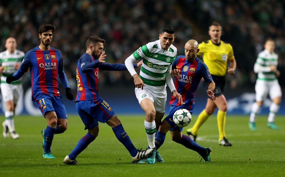 Celtic's Tom Rogic battles for the ball with Barcelona's Jordi Alba (left) and Javier Mascherano (right) 