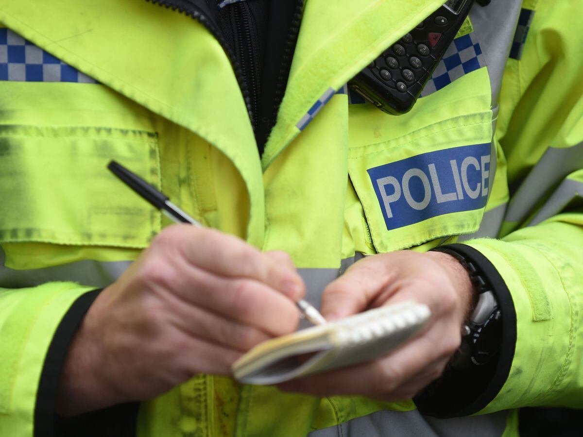 Police officer writes in notebook