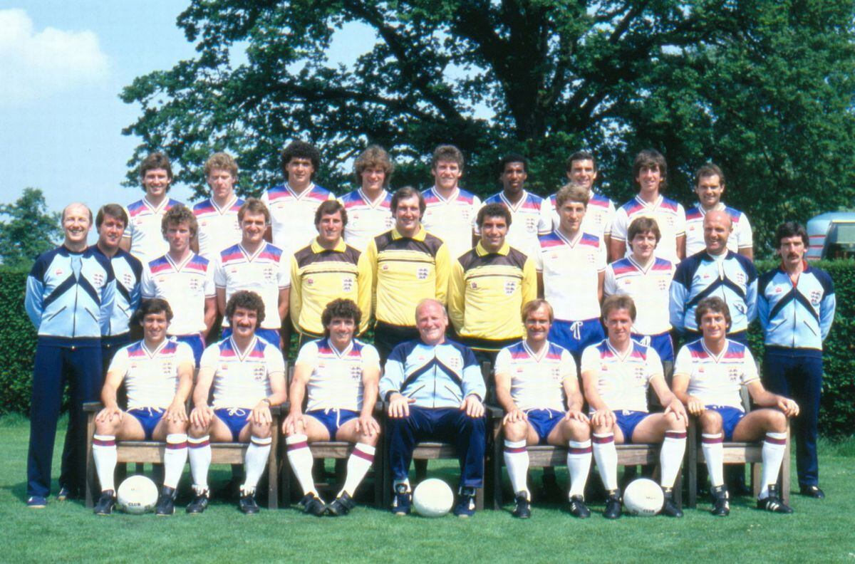 England manager Ron Greenwood (seated, centre) and his 1982 England World Cup squad photographed prior to going to Spain. (Back row left-right) Bryan Robson, Tony Woodcock, Steve Foster, Glenn Hoddle, Peter Withe, Viv Anderson, Trevor Brooking, Paul Mariner and Ray Wilkins. (Middle row left-right) Fred Street (physio), Geoff Hurst (assistant coach), Graham Rix, Phil Thompson, Ray Clemence, Joe Corrigan, Peter Shilton, Terry Butcher, Steve Coppell, Don Howe (coach) and Norman Medhurst (assistant physio). (Front row left-right) Kenny Sansom, Terry McDermott, Kevin Keegan, Ron Greenwood (manager), Mick Mills, Phil Neal and Trevor Francis. 