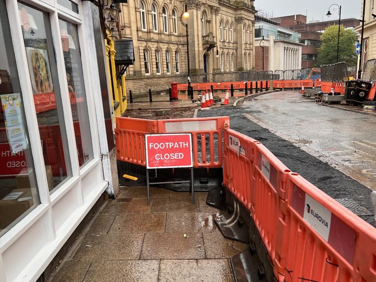 The pavement towards the bar is cut off by the barriers as works continue