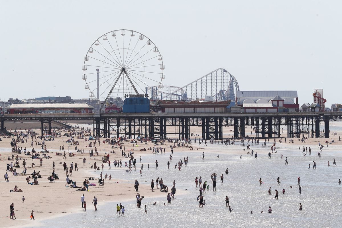 People enjoying the hot weather at Blackpool beach. Photo: Peter Byrne/PA Wire